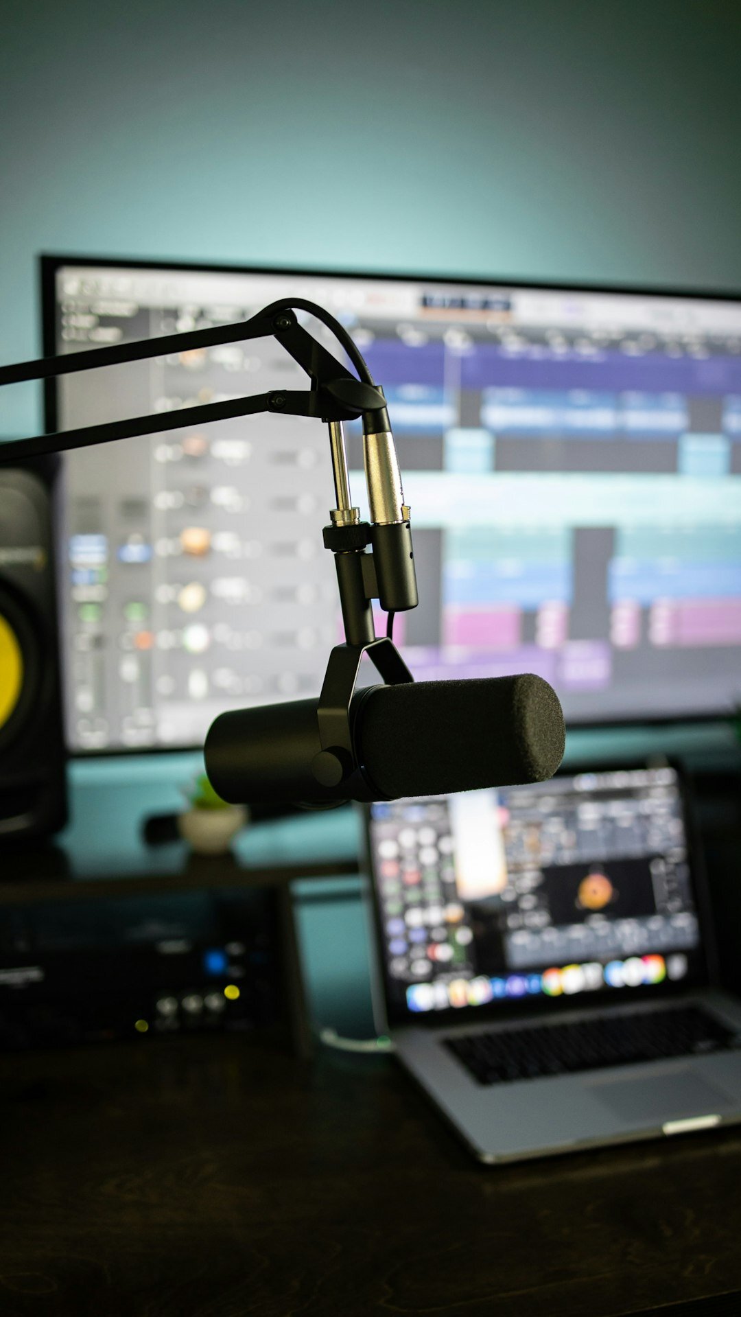 Close-up of a studio microphone with pop filter on a boom arm