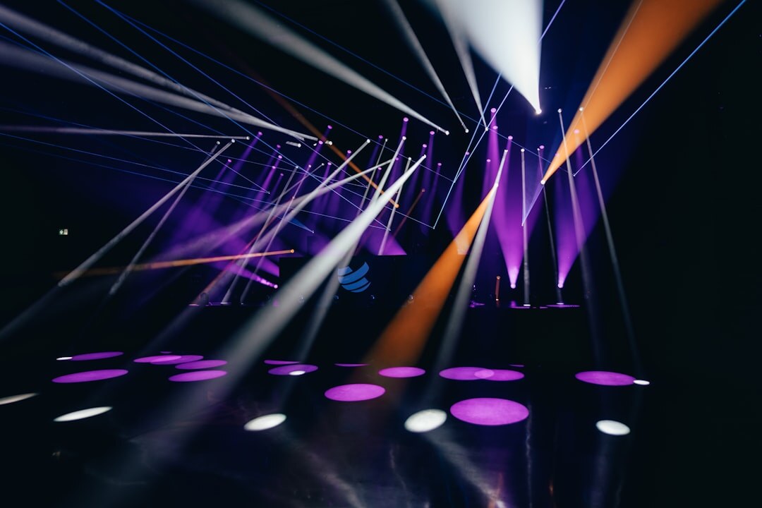 Colorful stage lighting beams during a live studio show